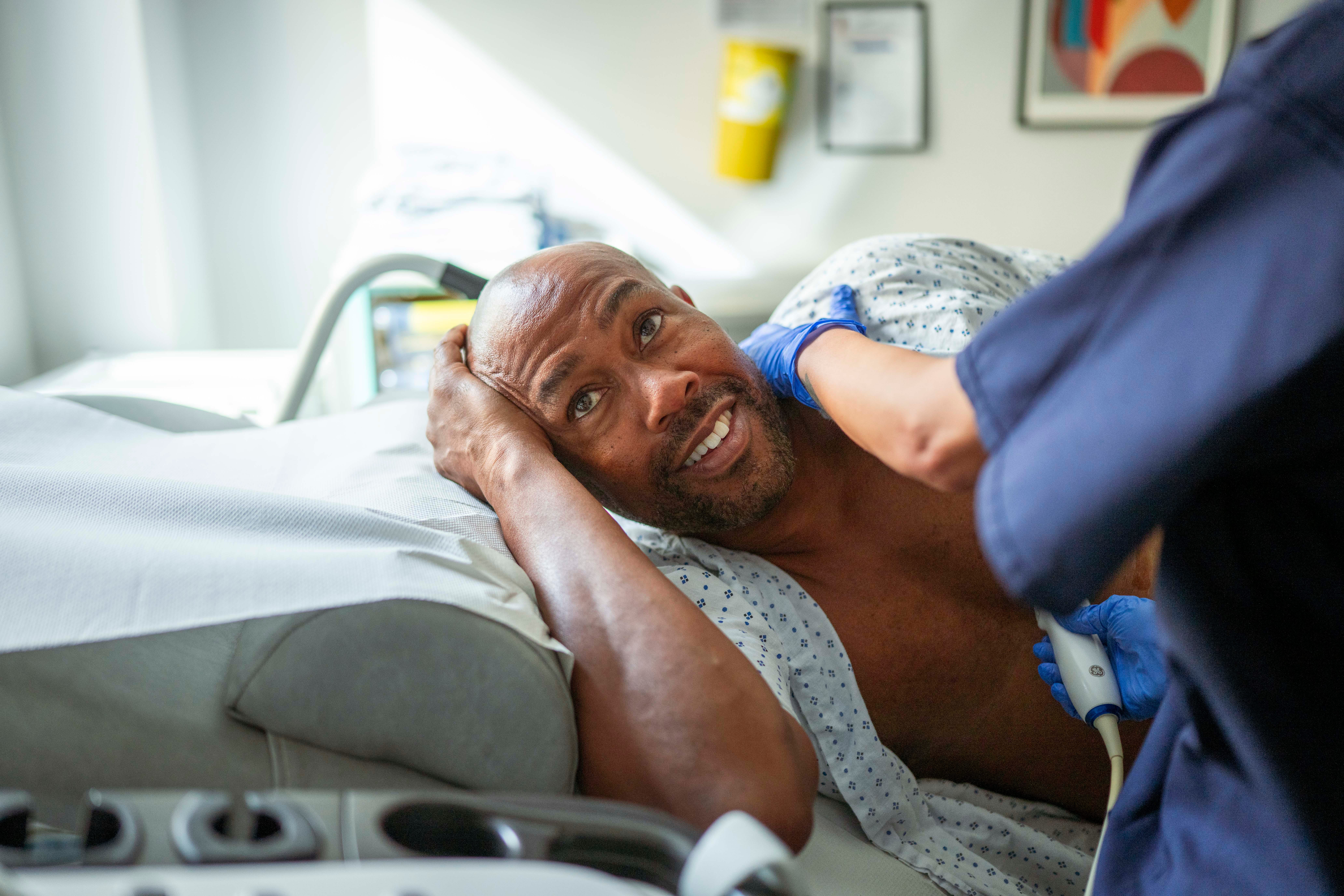 A man in his 50s speaking with a clinician during a prostate-health consultation